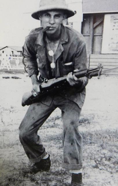 Dick Whitaker holding a rifle