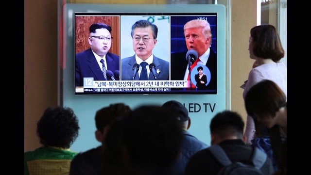 Koreans watching the news in Seoul