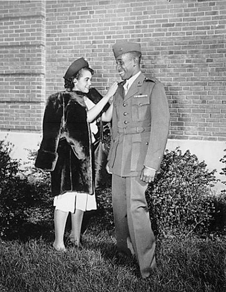 Peggy Branch proudly pins 2nd Lt. bars on her husband, Frederick Branch, November 10, 1945.