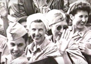 A joyous Bradley (center, waving) after being released from Japanese imprisonment, 1945.