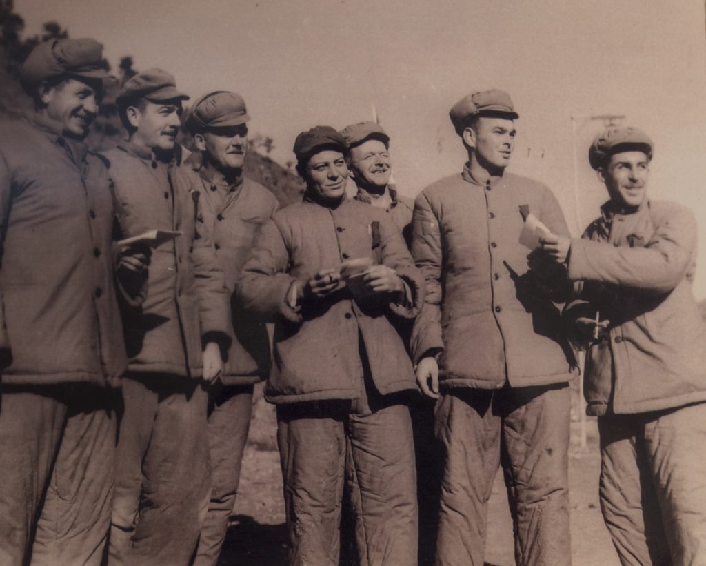 Lt. Funchess (second from right), with fellow prisoners, in a staged propaganda photo. (PC: Frank Noel)