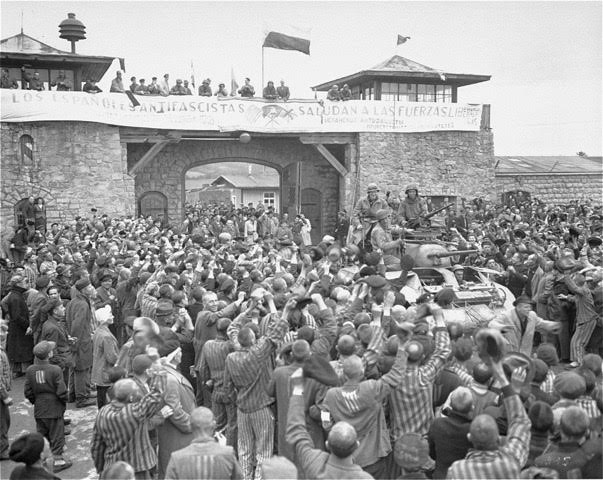 A photograph taken on May 6, 1945, the day after the liberation of Mauthausen concentration camp, shows prisoners surrounding an M8 Greyhound armored car. The 11th Armored Division, US Third Army, liberated the camp on May 5, 1945, and General Dwight D. Eisenhower ordered that the event be re-enacted the next day so that more photographs could be taken of the atrocities committed by the Nazis. (PC: National Archives)