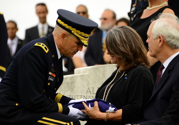 Barbara Broyles receiving a flag at the funeral of her father in August 2013