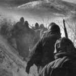 Marines making their way out of the Chosin Reservoir towards the port of Hungnam in early December 1950. John Lee was with them every step of the way.